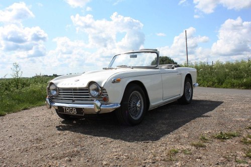 1965 TR4A. WHITE WITH BLACK INTERIOR AND OVERDRIVE SÅLD