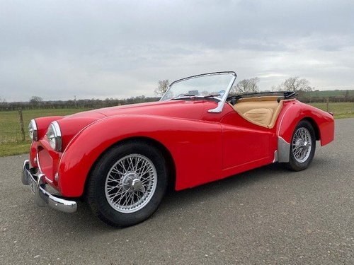 1955 Triumph TR2. Red with tan interior and a black hood SOLD